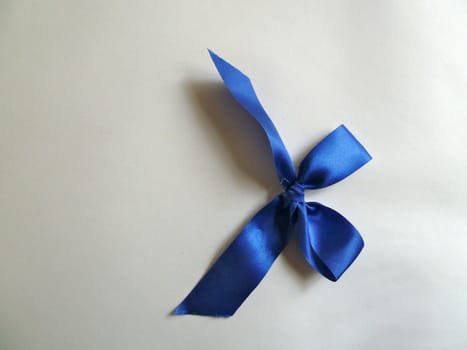 Bright blue ribbon on a plain white background