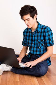 Young man working on computer laptop at home