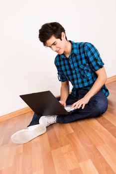 Young man working on computer laptop at home