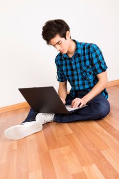 Young man working on computer laptop at home