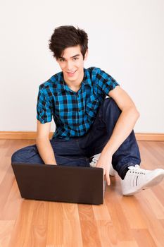 Young man working on computer laptop at home