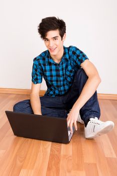 Young man working on computer laptop at home