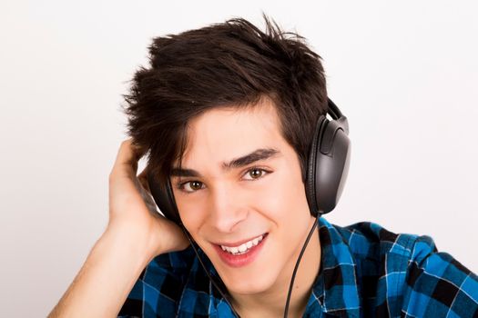 Young man listening music with headphones at home