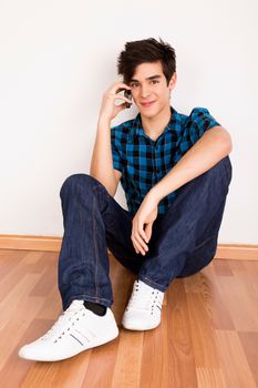 Young man talking on the phone at home