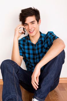 Young man talking on the phone at home