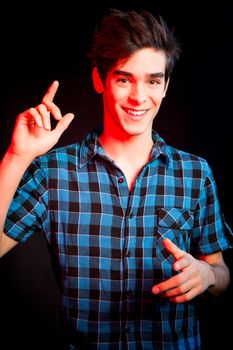 Young man dancing and enjoying music at disco