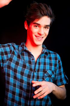 Young man dancing and enjoying music at disco