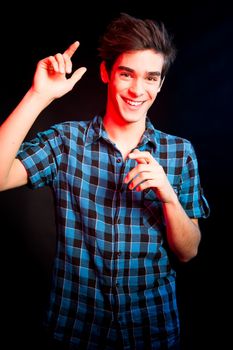 Young man dancing and enjoying music at disco