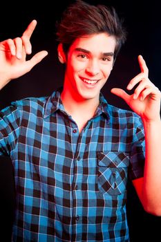 Young man dancing and enjoying music at disco