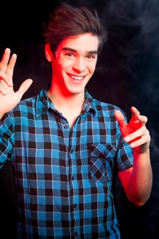 Young man dancing and enjoying music at disco