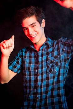 Young man dancing and enjoying music at disco