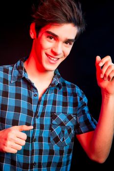 Young man dancing and enjoying music at disco