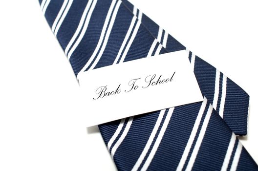 Back to school tag on blue tie over white background