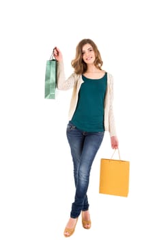 Beautiful woman holding shopping bags over white backgroung