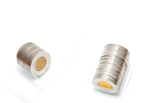 Plastic roll holding two dollar coins on white background