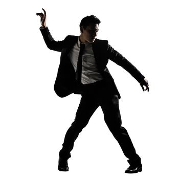 Silhouette of Asian businessman dancing or posing, isolated on white background.