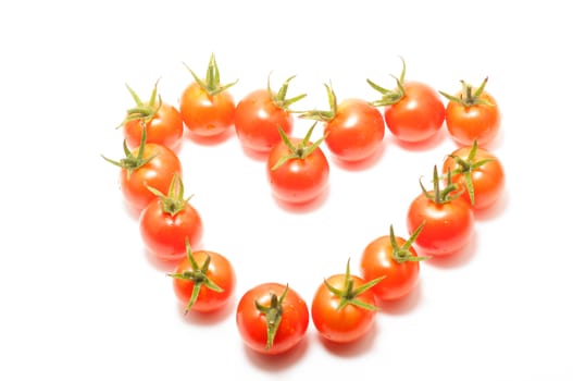 Cherry tomatoes heart shape on white background