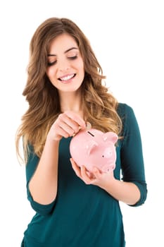 Casual woman looking to save money in a piggy bank