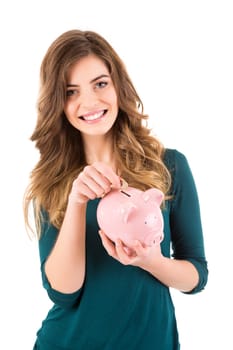 Casual woman looking to save money in a piggy bank