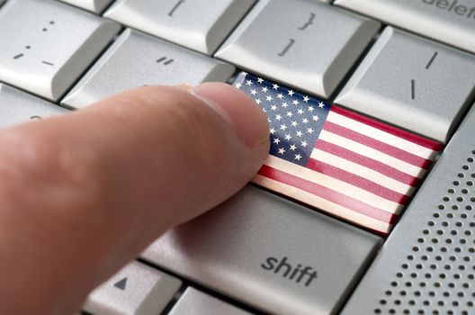 Business concept male finger pressing USA enter key on metallic keyboard