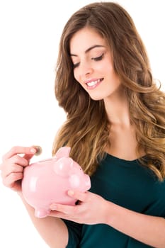 Casual woman looking to save money in a piggy bank