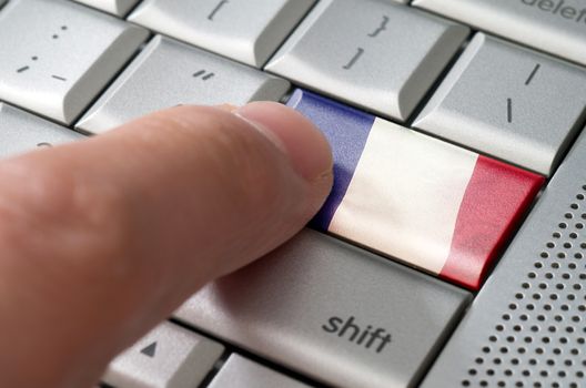 Business concept male finger pressing France enter key on metallic keyboard