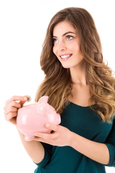 Casual woman looking to save money in a piggy bank