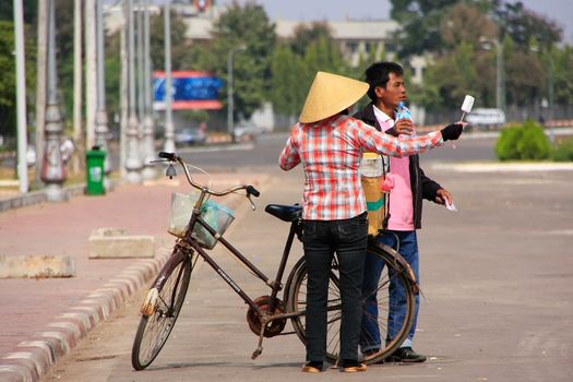 Local woman selling ice cream on the street, Vientiane, Laos, Southeast Asia