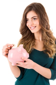 Casual woman looking to save money in a piggy bank