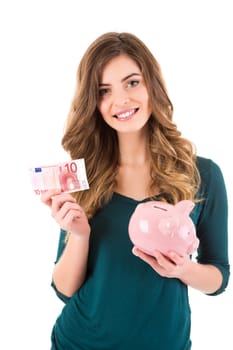 Casual woman looking to save money in a piggy bank