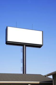 Blank billboard with space for your advertisement against blue sky