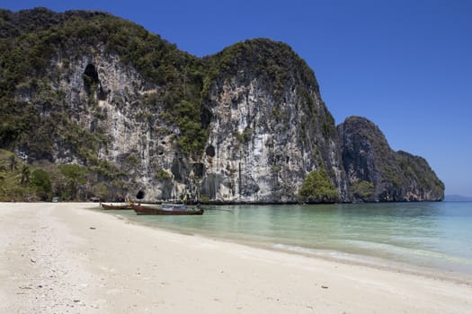 Boats moores on beach in Koh Rok Yai, Trang Province, Thailand