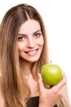 Portrait of a young woman eating green apple