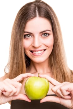 Portrait of a young woman eating green apple