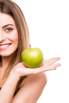 Portrait of a young woman eating green apple