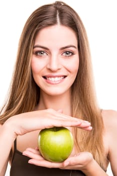 Portrait of a young woman eating green apple