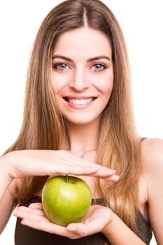 Portrait of a young woman eating green apple