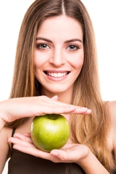 Portrait of a young woman eating green apple