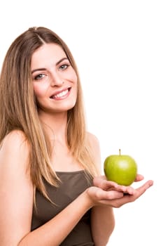 Portrait of a young woman eating green apple