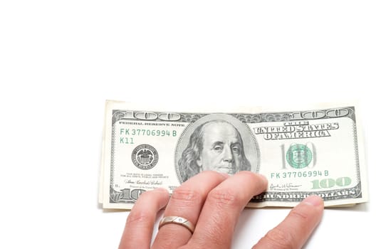 Hand holding a series of banknotes with 100 dollars on top on white background