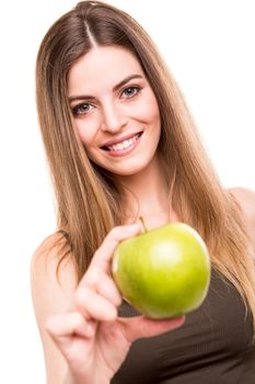 Portrait of a young woman eating green apple