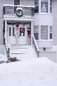 Entrance with Christmas decorations filled with snow
