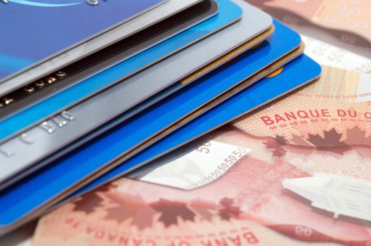 Stack of credit cards on a bank note