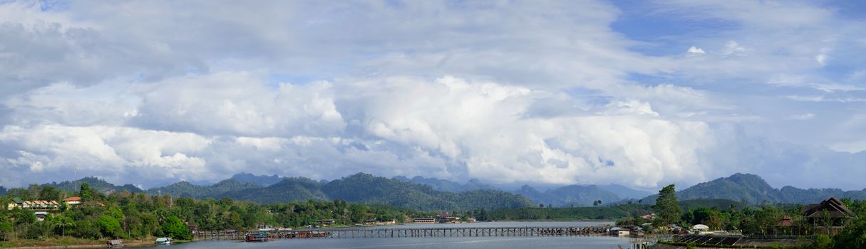 panorama of Sangklaburi. A wooden bridge over the river and raft accommodation for tourists.