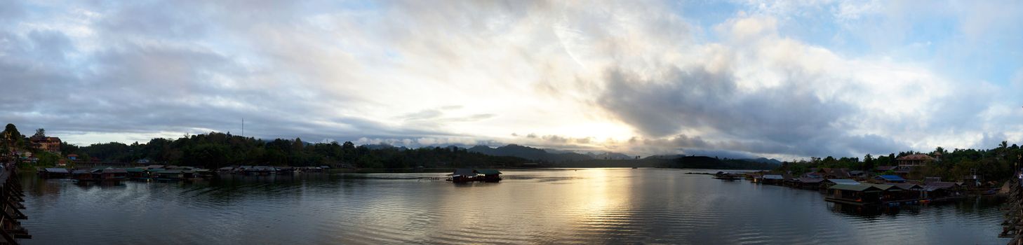 panorama of Sangklaburi. A wooden bridge over the river and raft accommodation for tourists.