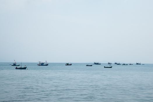 Small boat moored at sea. Small fishing boats moored offshore.