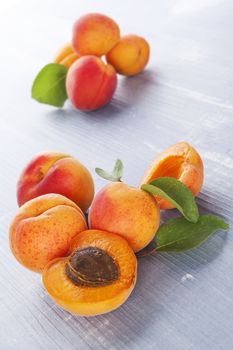 Fresh ripe apricots on blue wooden background. Healthy fresh summer fruit eating. 