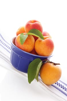 Apricots background in white and blue, modern minimal style. Healthy eating. 