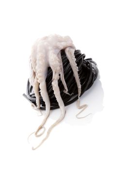 Fresh octopus with black pasta isolated on white background. Culinary seafood eating. 