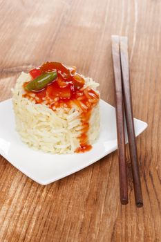 Traditional chinese chop suey on wooden background with chopsticks. Culinary asian eating. 